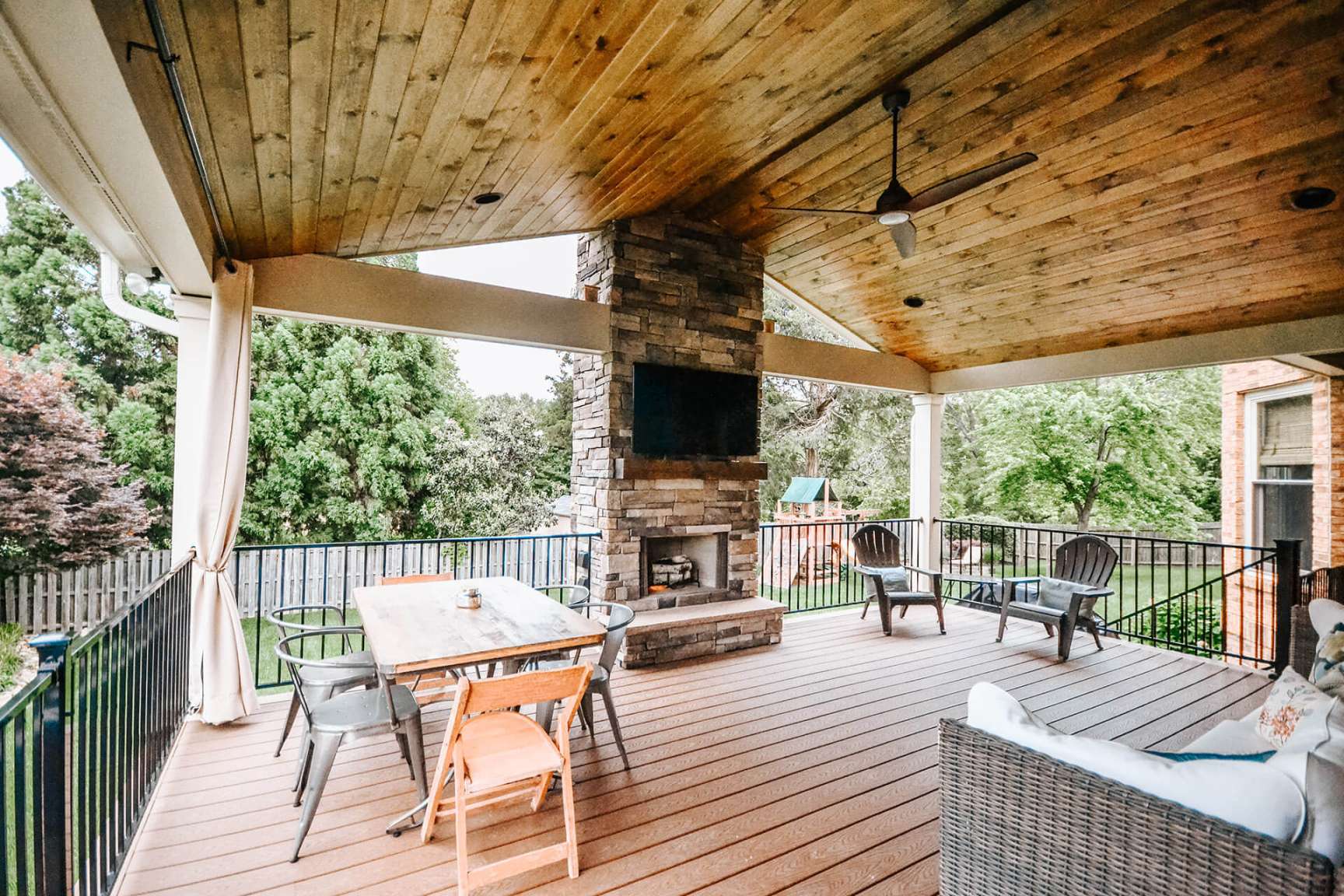 Cozy Outdoor Living: Covered Deck With Fireplace Extends Living