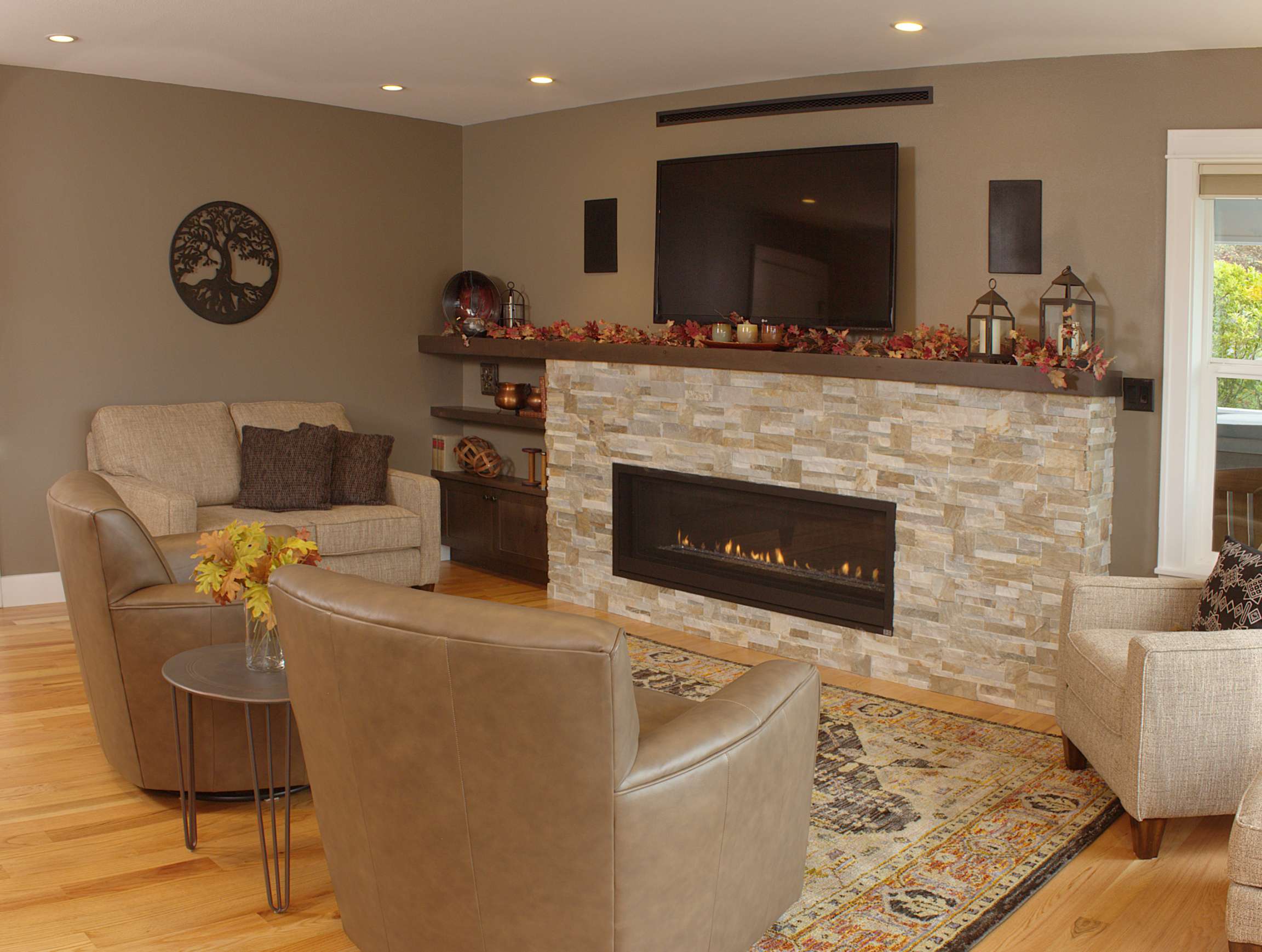 Family Room with a Stacked Stone Fireplace and a Wall-Mounted