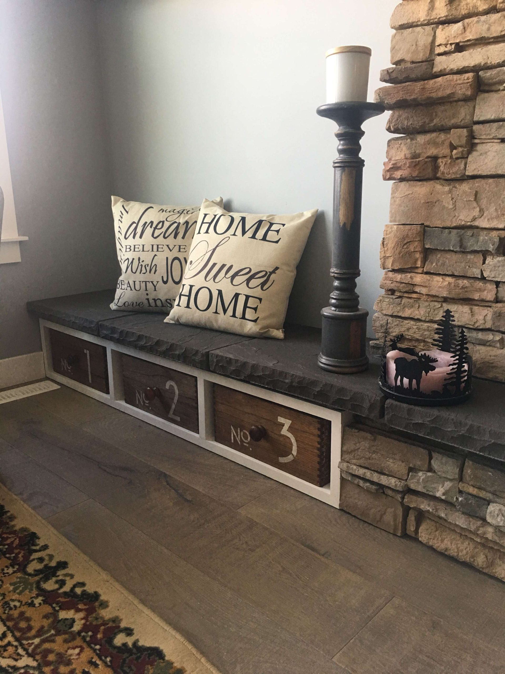 Fireplace hearth seating with stencilled repurposed Jysk wooden