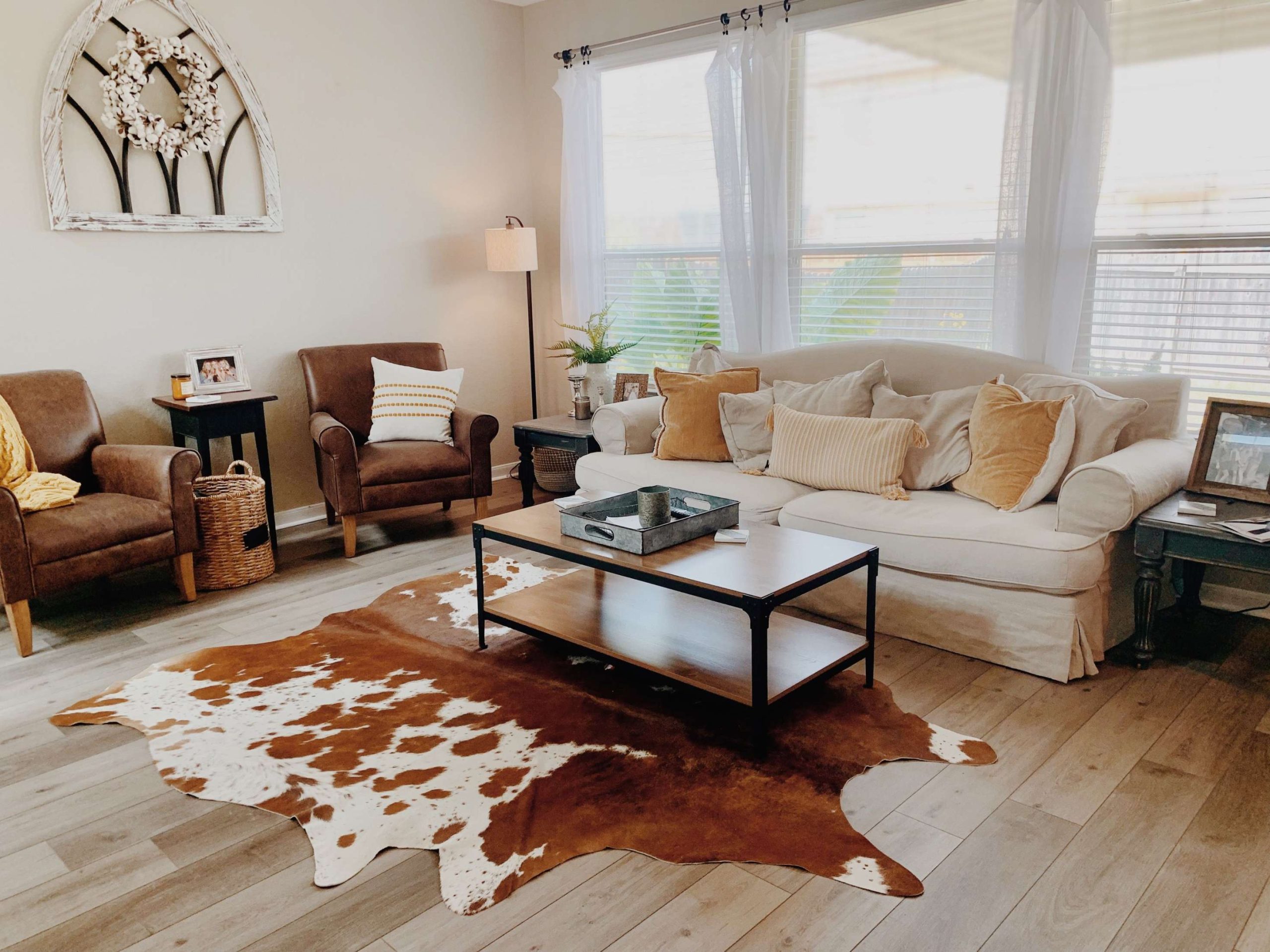 modern farmhouse with mustard accents  Cowhide rug living room