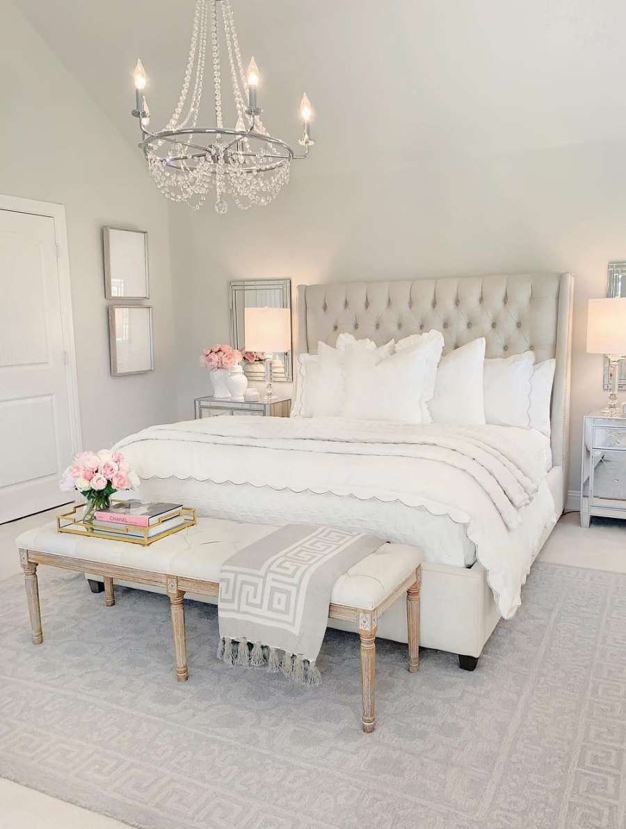 Neutral beige tufted headboard in bedroom with white tufted end of