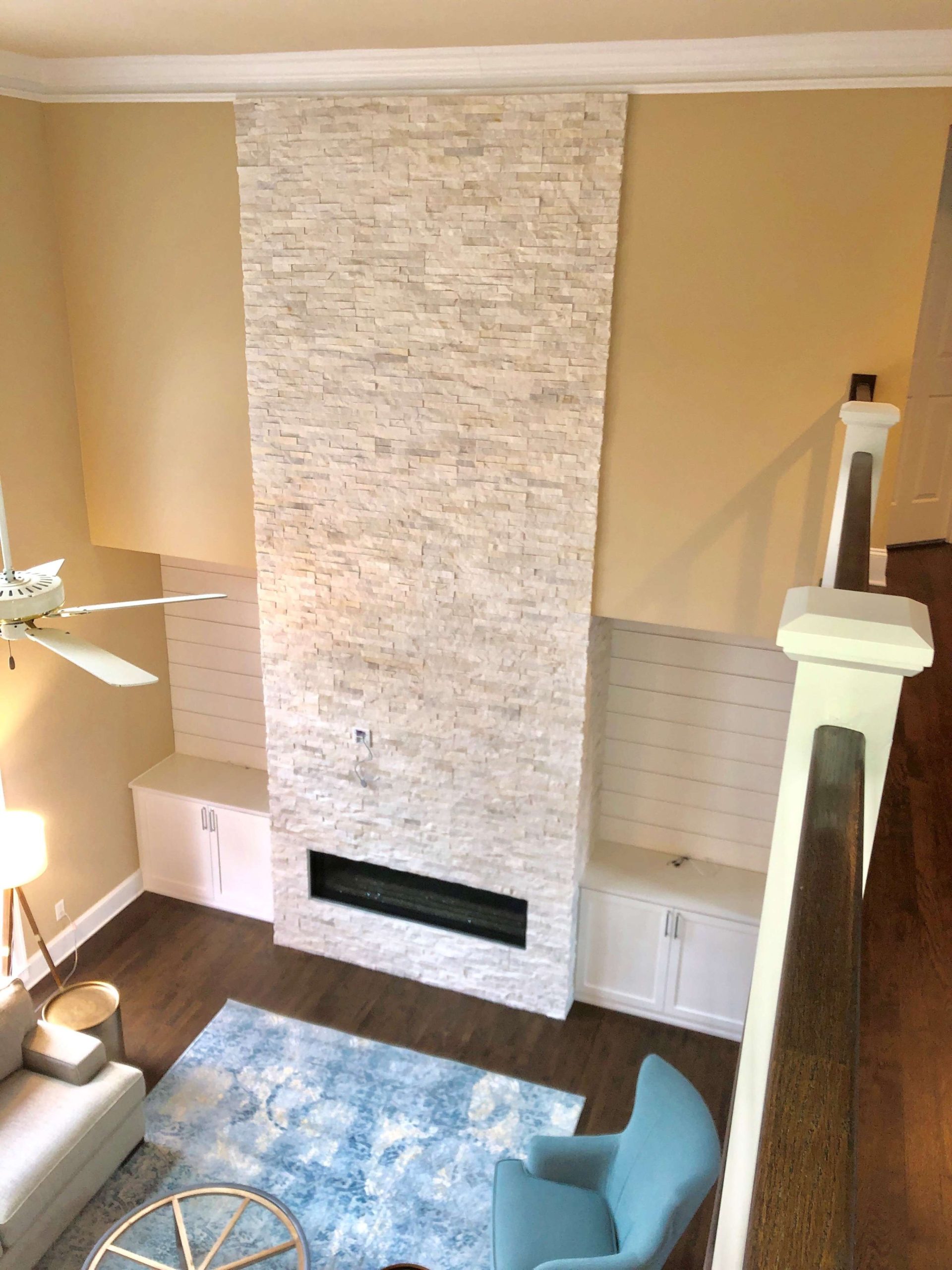 Two Story White Stacked Stone Fireplace