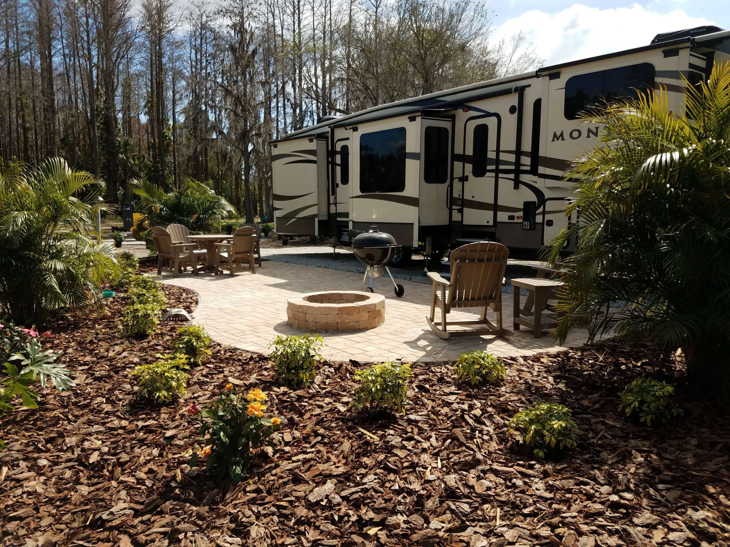 Expansive and lush landscaping surround this RV patio site at the
